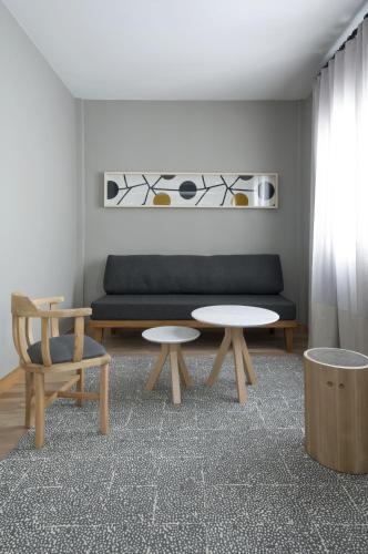 a living room with a couch and a table and chairs at Hotel Arenales in Buenos Aires