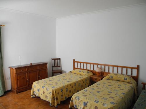 a bedroom with two beds and a dresser and a table at Apartamentos Colombia Ap 5 in Puerto del Carmen