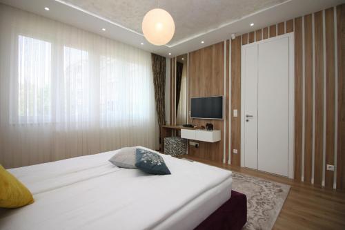 a hotel room with a bed and a television at Radiceva Apartment in Sarajevo