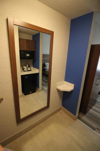 a mirror in the corner of a hotel room at Holiday Inn Express & Suites Houston - Memorial Park Area by IHG in Houston