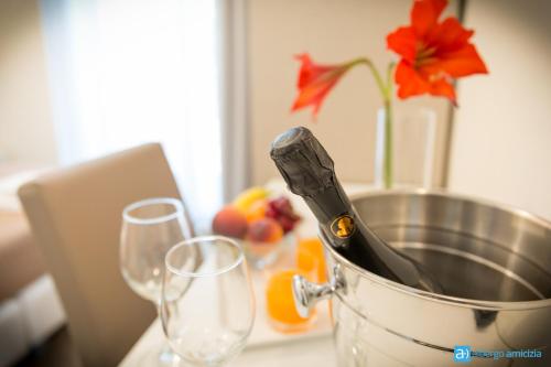 two wine glasses and a bucket on a counter with a table with at Hotel Amicizia in Rimini