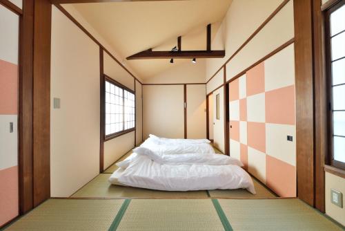 Postel nebo postele na pokoji v ubytování Comfortable House In Fushimi