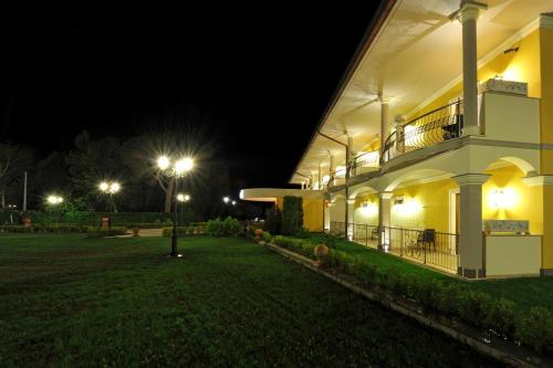 a night view of a building with street lights at Hotel Lido - Beach and Palace in Bolsena
