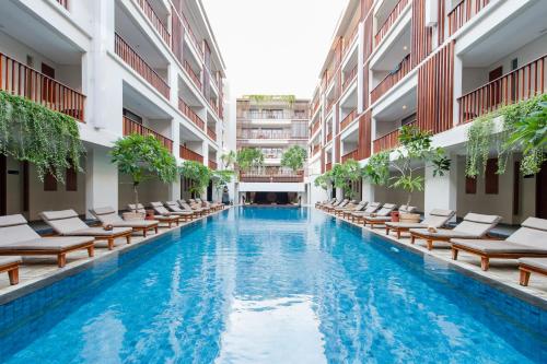 a swimming pool in the middle of a building at The Magani Hotel and Spa in Legian
