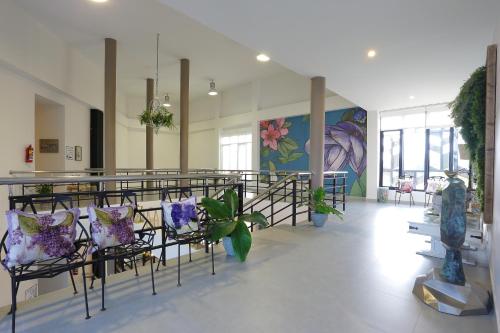 a lobby with chairs and a table with plants at Play La Ploen Boutique Resort and Adventure Camp in Ban Nong Khaman