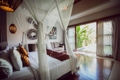 Aria Exclusive Villas & Spa - CHSE Certified tesisinde bir odada yatak veya yataklar