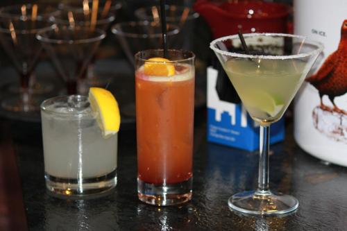 three cocktails sitting on a table at Mackays Hotel in Wick
