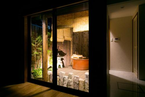 a view of a bathroom through a sliding glass door at Kyotoya Tsukinoyu Kukai in Kyoto
