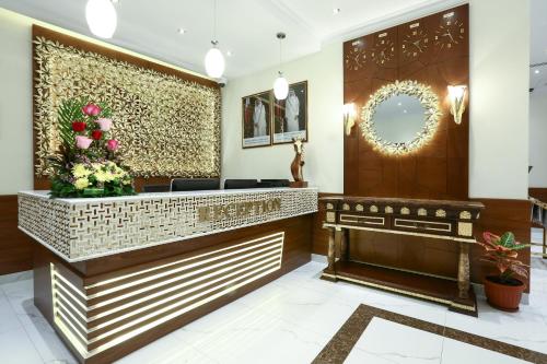 a lobby of a hotel with a reception desk at La Villa Suites Hotel in Doha