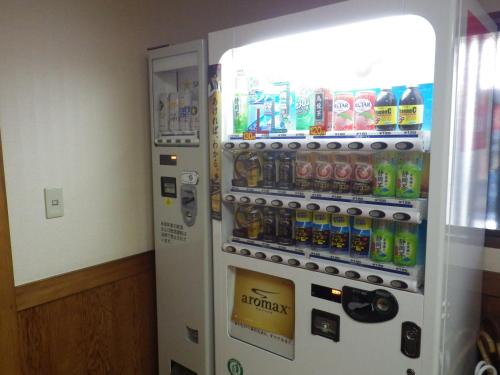 a refrigerator filled with lots of bottles of soda at Uokagi Ryokan in Nagoya