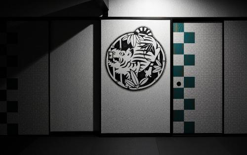a door with a picture of a lion on it at Goyokan in Izu