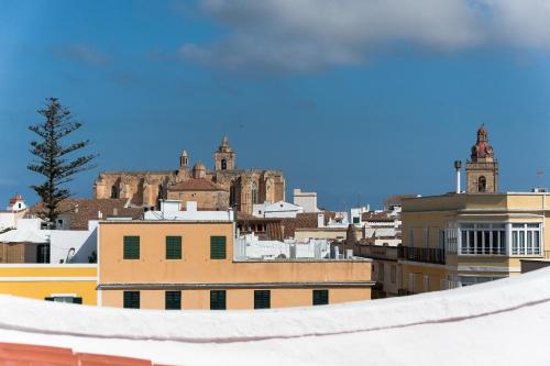 a view of a city with a castle in the background at Sodium Boutique Hotel in Ciutadella