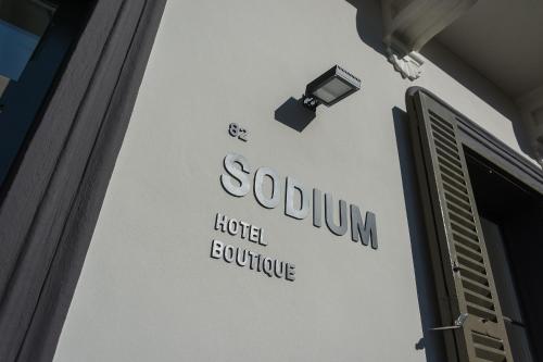 a sign on the side of a building at Sodium Boutique Hotel in Ciutadella