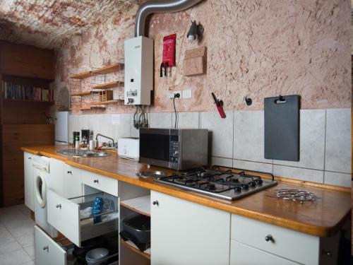 a kitchen with a stove and a counter top at Ali's Underground Studio in Coober Pedy