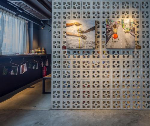 a wall with two paintings and two paintings on it at attitude on granville in Hong Kong