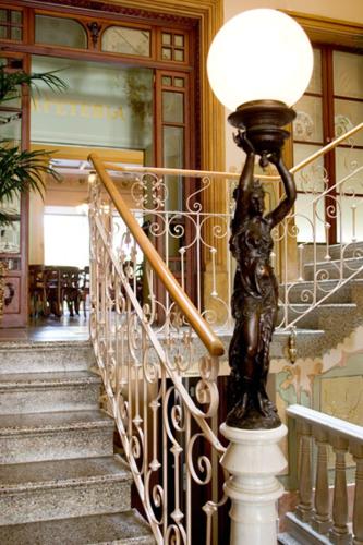 a statue of a woman on a lamp on a staircase at Hotel la Vila in Sóller