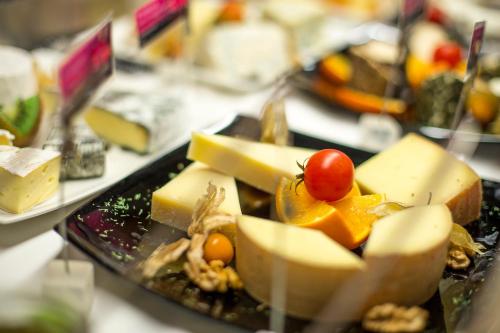 a plate of cheese and fruit on a table at Alpen-Herz Romantik & Spa - Adults Only in Ladis