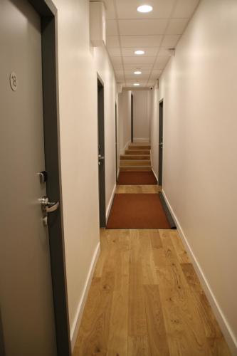 a corridor of an office building with a hallway at Hotel Saint Vincent in Lyon