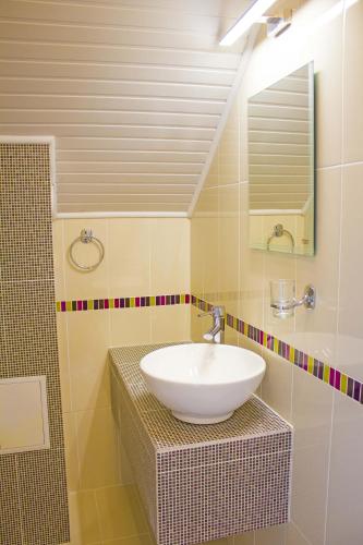 a bathroom with a sink and a mirror at Complex Chayka Guest House in Byala