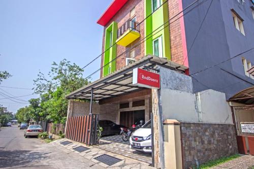 a building with a sign on the front of it at RedDoorz near Trans Studio Mall 2 in Bandung