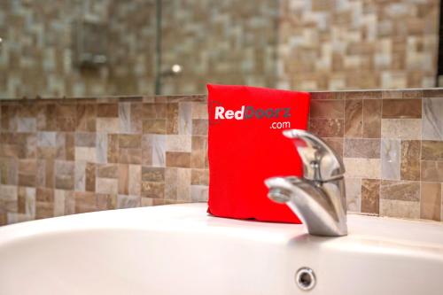 a red book sitting on top of a sink at RedDoorz near Trans Studio Mall 2 in Bandung