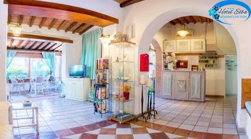 a large room with a kitchen and a living room at Hotel Elba in Marina di Campo