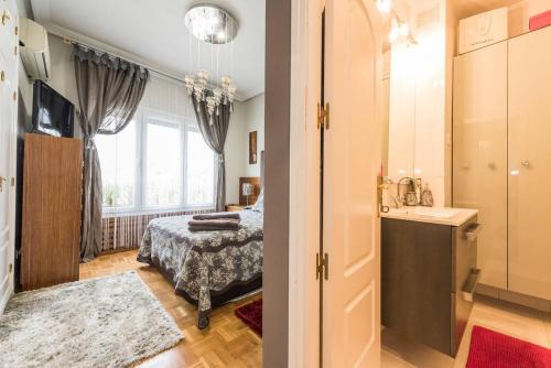 a bathroom with a bed and a sink in a room at Apartamento en Chamberi in Madrid