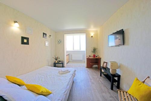 a bedroom with two beds and a tv on the wall at 54a Tselinogradskaia Str at Alekseevka underground in Kharkiv