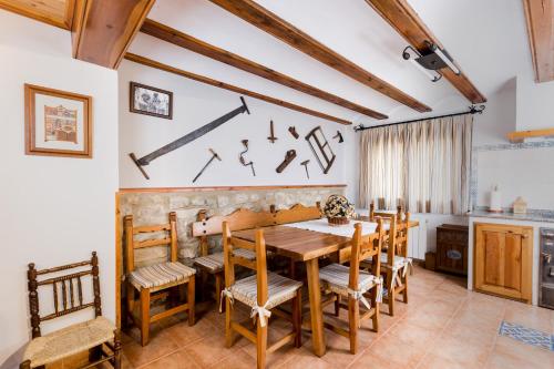 a dining room with a wooden table and chairs at Casa La Carpintera in Royuela