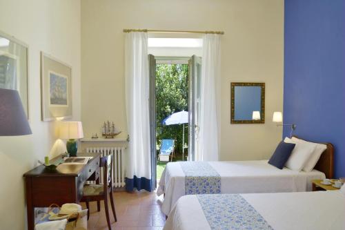 a bedroom with two beds and a sink and a window at Apartment I Fontanili in Pescia Romana