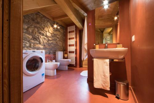 a bathroom with a washing machine and a washer at L'Atelier du Temps - Le matin clair in Aosta