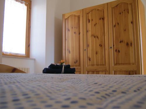 a bedroom with a bed and wooden cabinets at Agriturismo Bellavista in Ronzano
