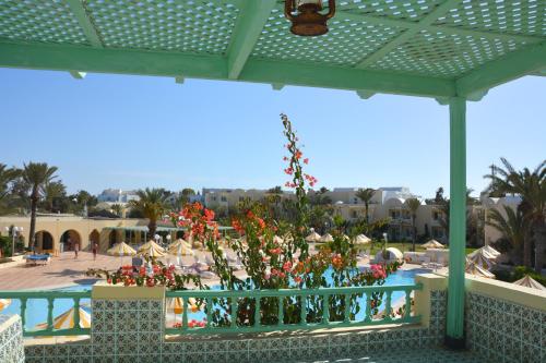 a view of a resort with a pool and flowers at Hotel Venice Beach- Families and Couples Only in Triffa