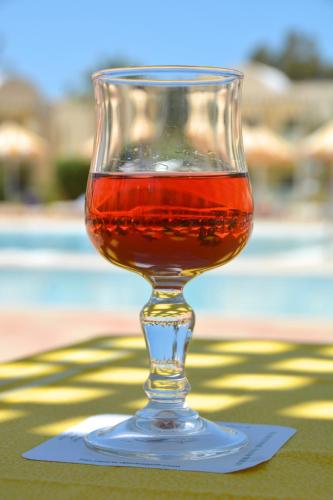 a wine glass sitting on top of a table at Hotel Venice Beach- Families and Couples Only in Triffa