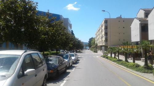 a street with cars parked on the side of the road at Dena apartman Tivat in Tivat