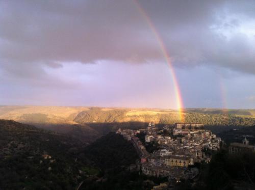 a rainbow in the sky over a city at La Chiave di Volta in Ragusa