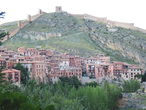 a city on top of a hill with a castle at Casa La Carpintera in Royuela