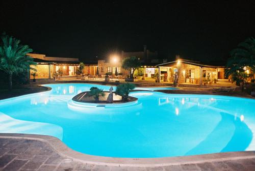 a large blue swimming pool at night at Agroturismo Finca Sa Tanca in Cala d´Or