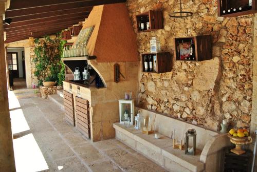 a kitchen in a stone wall with a counter at Agroturismo Finca Sa Tanca in Cala d´Or