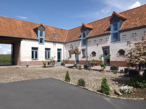 a large white building with red roof at Le gite des Menhirs in Mont-Saint-Éloi