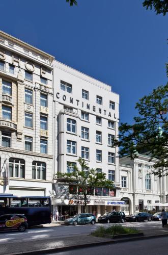a white building with a sign on the side of it at Hotel Continental Hamburg Hauptbahnhof in Hamburg