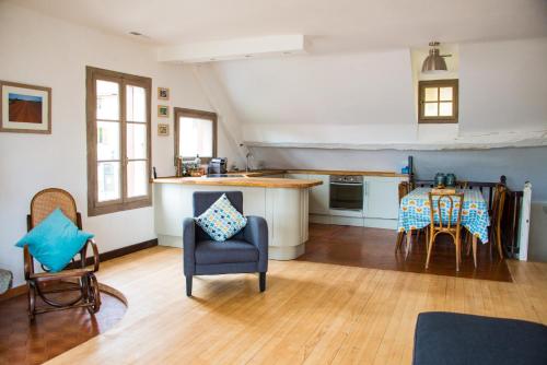 een keuken en een woonkamer met een tafel en stoelen bij La Villanelle - Magnifique vue sur le lac, 5 minutes à pied de la plage in Veyrier-du-Lac