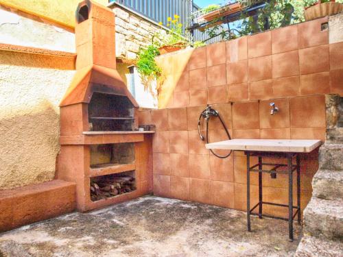 a outdoor kitchen with a sink and an outdoor oven at Apartments Antica in Pula