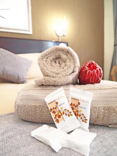 a hotel room with a bed with a towel and a towel at Travel Lodge Sabie in Sabie