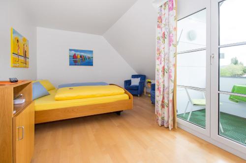 a small bedroom with a bed and a window at Apart Hotel Stadtgarten in Überlingen