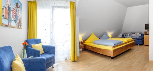 a bedroom with a bed and a blue chair at Apart Hotel Stadtgarten in Überlingen