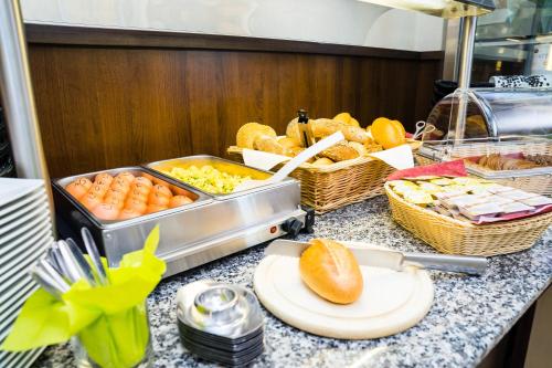 a buffet with bread and other foods on a counter at Kurhotel Bad Schlema in Bad Schlema