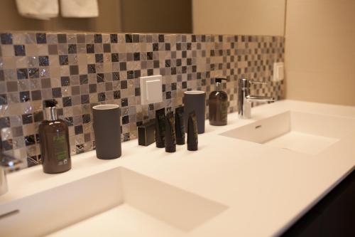 a bathroom counter with two sinks and a mirror at Best Western Hotel Tulln in Tulln