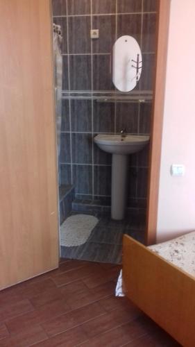 a bathroom with a sink and a toilet and a shower at Seven Stars in Sumy