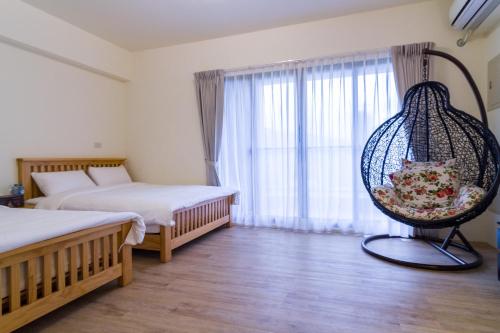 a bedroom with two beds and a swing at Wendy's home Toucheng Mansion A in Toucheng